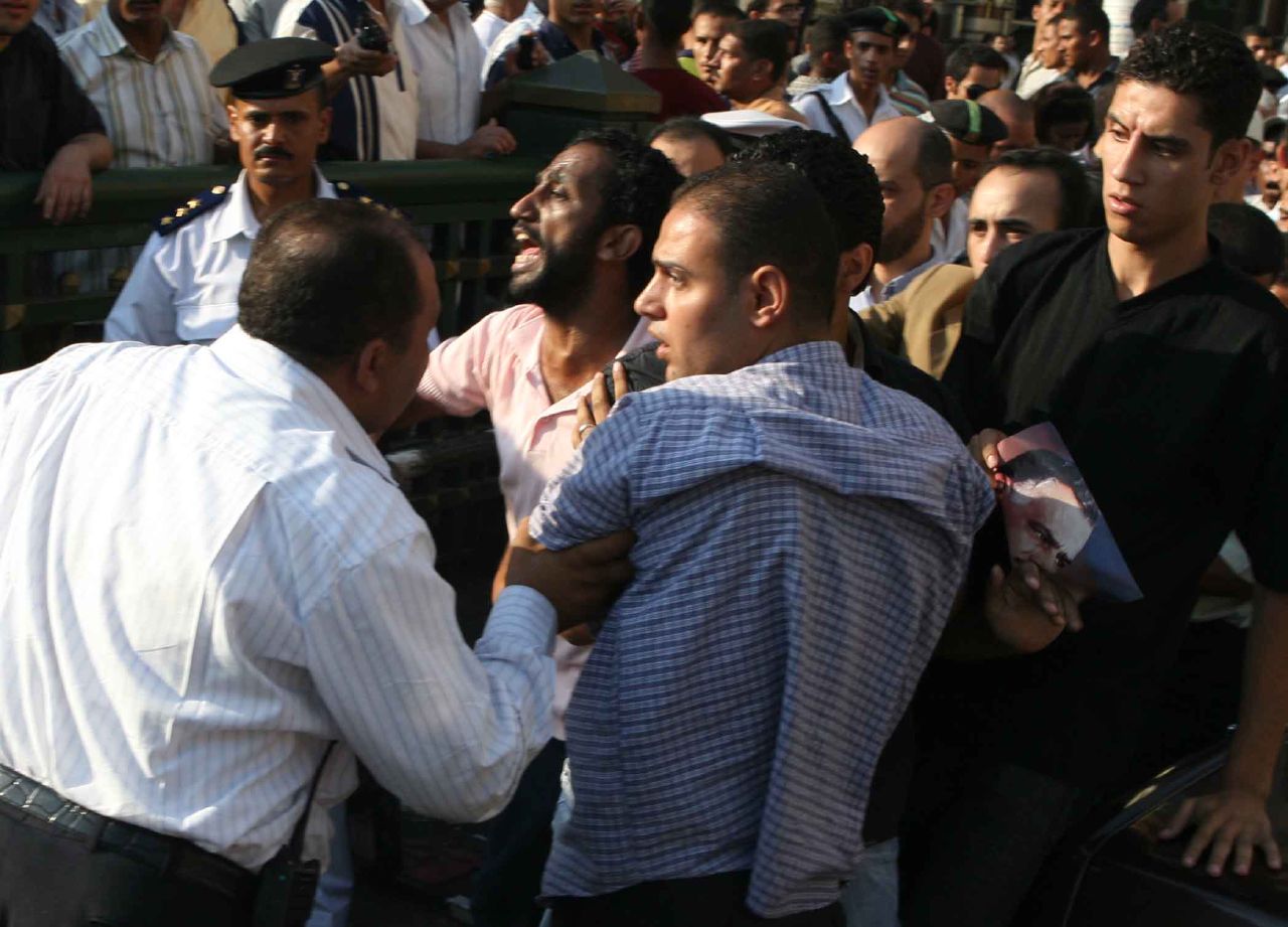 State Security agents attacked activist Khaled Abdel Hamid, while marching in Talaat Harb St., towards Tahrir Square. The agents tried to snatch Khaled away. Other activists managed to hold the police back (Photo by Amr Abdallah, 26 July 2006)