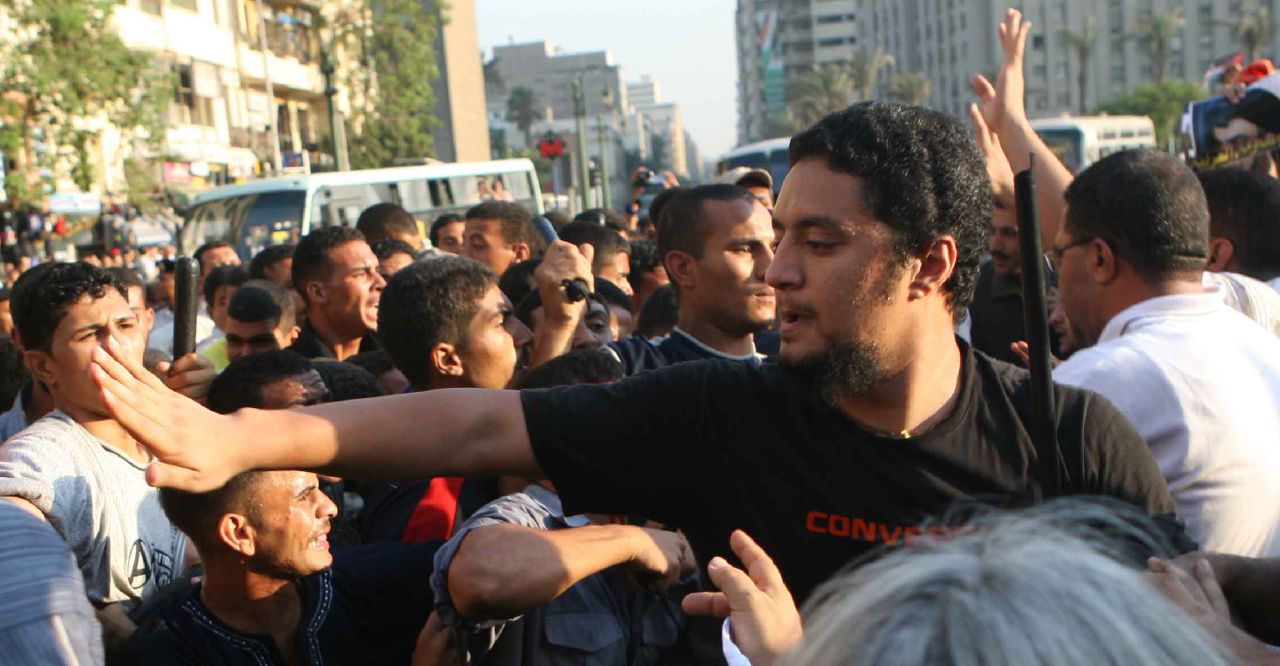 Blogger Malek Mustafa trying to stop the thugs' attack, in Tahrir Square (Photo by Amr Abdallah, 26 July 2006)