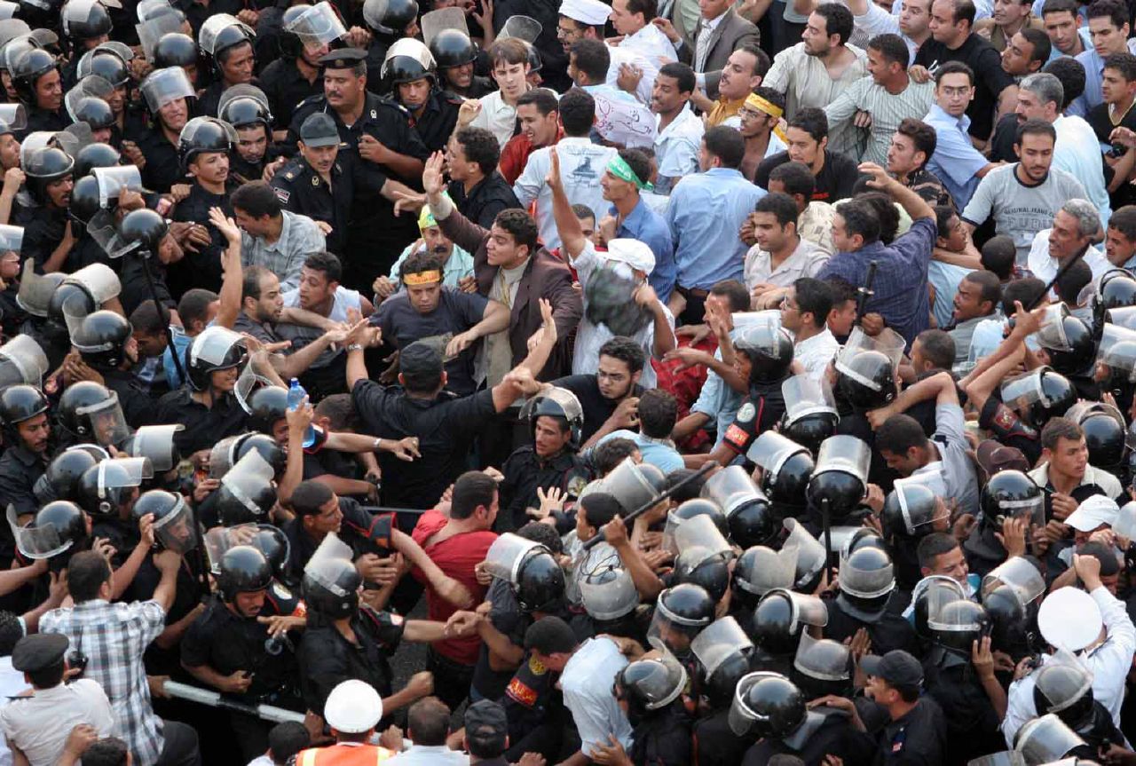 CSF troops clash with pro-resistance protesters. Journalist Jano Charbel (wearing a red shirt) was brutally attacked by CSF and plainclothes thugs, who stole his mobile phone and money, while covering the demo (Photo by Nasser Nouri)