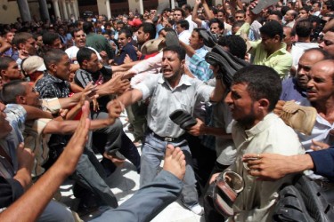 Police-deployed plainclothes thugs crack down on pro-Lebanese resistance demonstrators, at Al-Azhar Mosque, 11 August 2006. Photo by Nasser Nouri